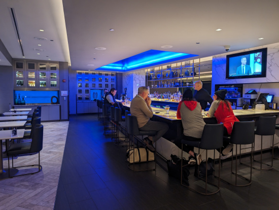 a group of people sitting at a bar