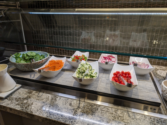 a salad bar with different kinds of vegetables