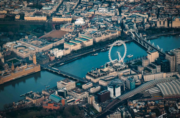 a city with a river and a ferris wheel