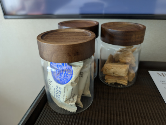 a group of glass jars with brown lids