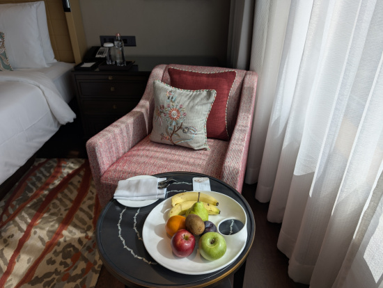 a plate of fruit on a table in a hotel room