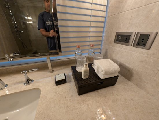 a bathroom sink with a mirror and a mirror and a mirror