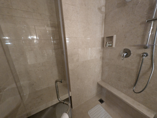 a shower with a shower head and a shower head