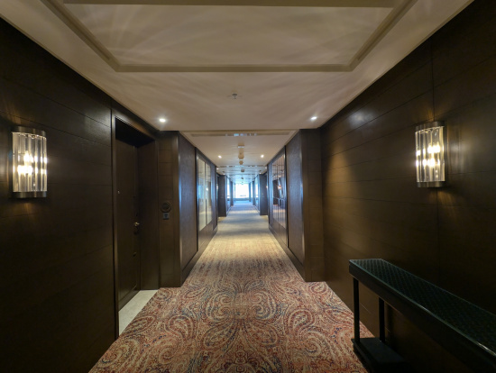 a hallway with a bench and doors