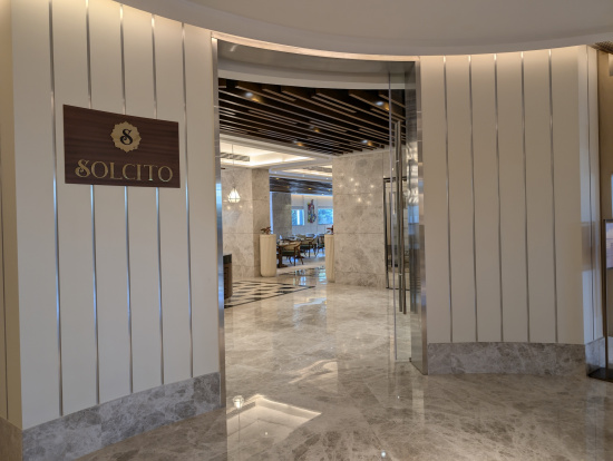 a lobby with a marble floor and a sign