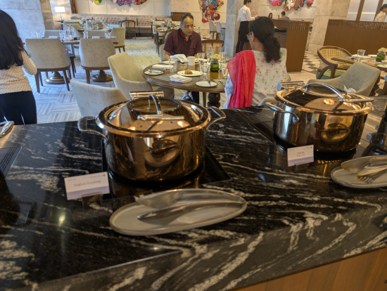 a group of people sitting at a table with food on it