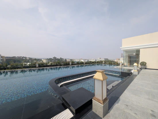 a pool with a bar and a building in the background