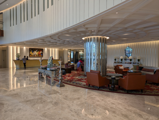 a lobby with a large round table and chairs