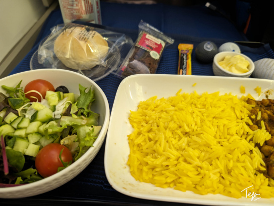 food on a tray with a bowl of rice and salad