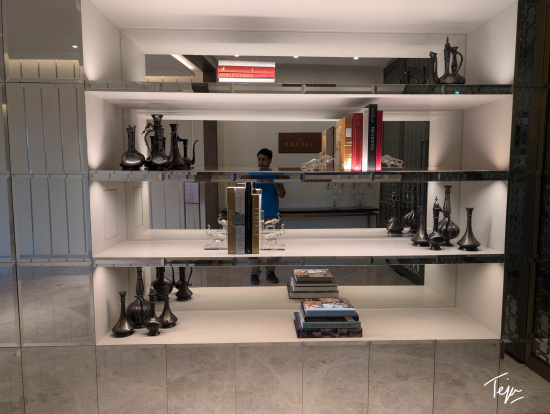 a shelf with books and vases on it