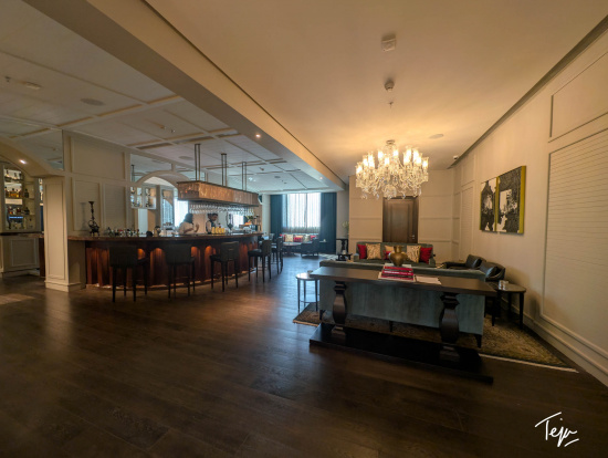 a room with a bar and a chandelier