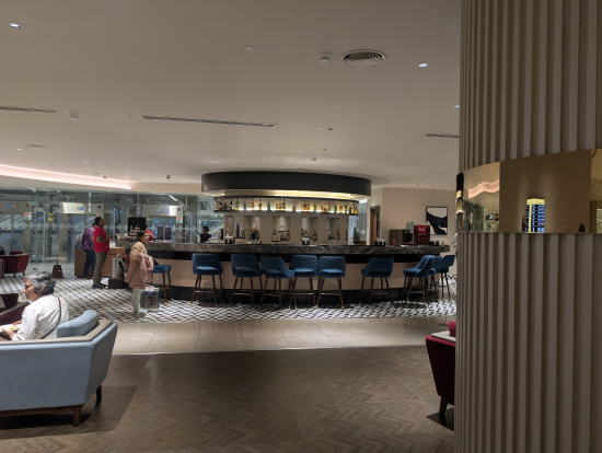 a room with a bar and chairs