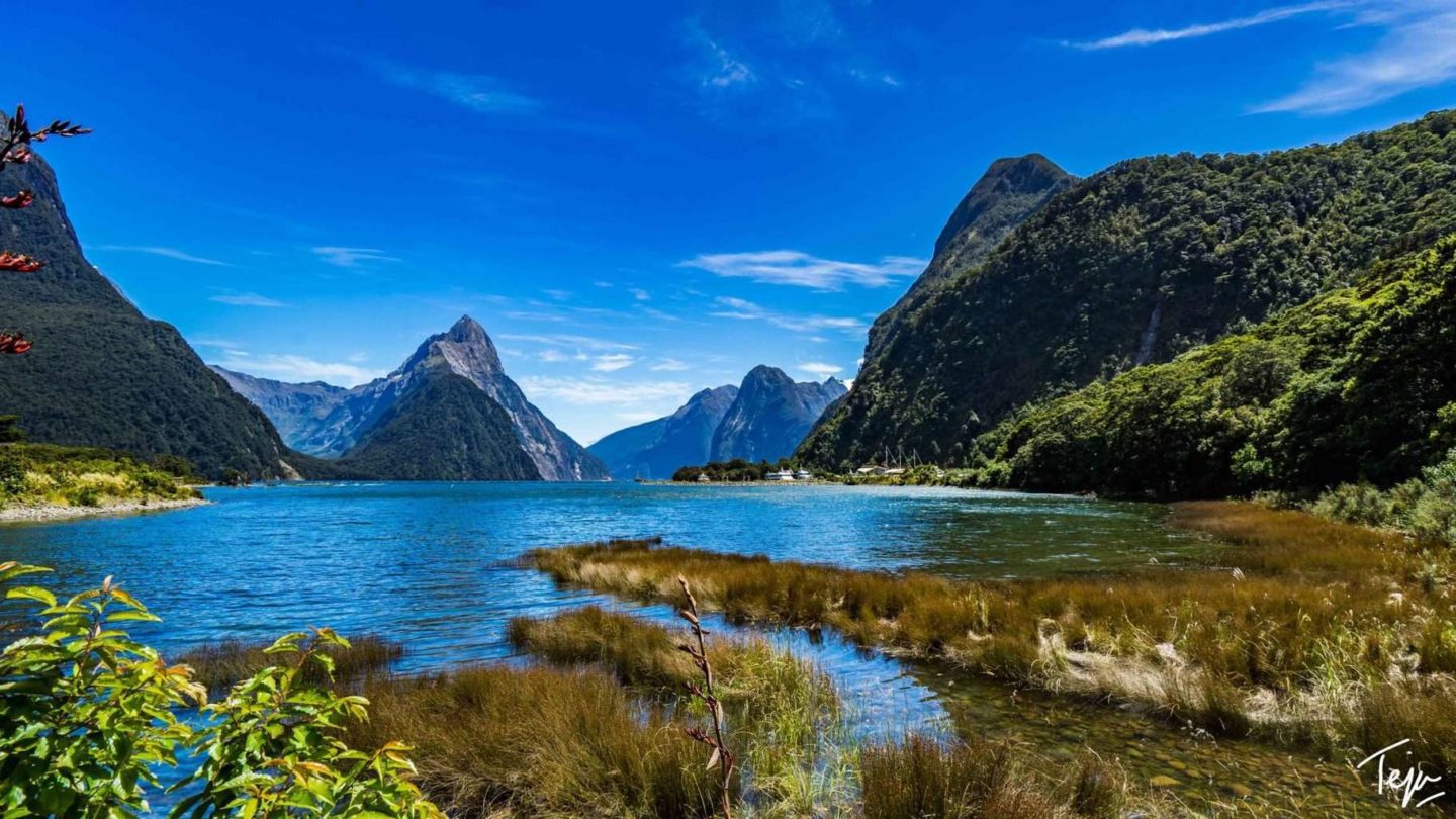 a body of water with mountains in the background