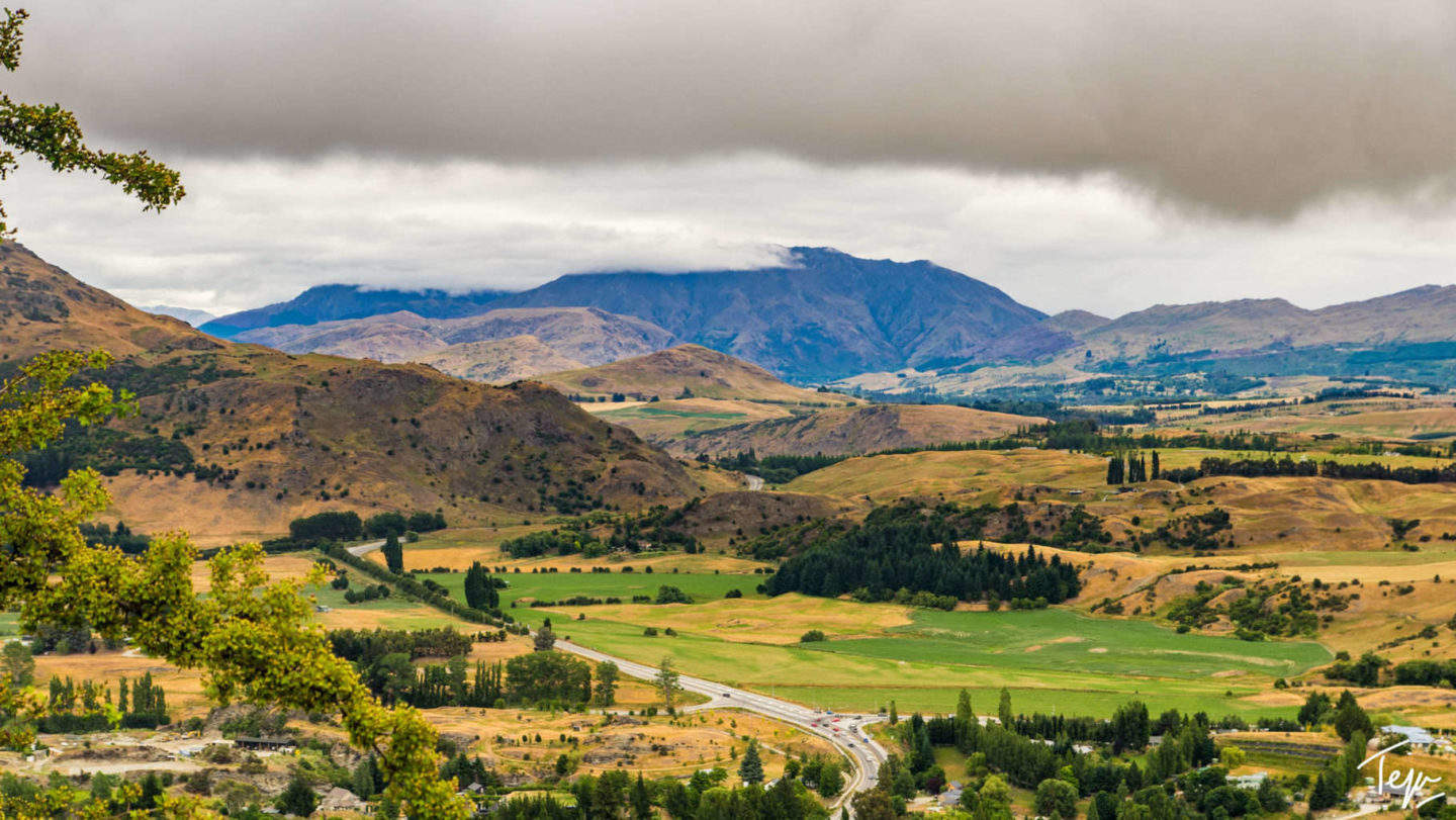 a landscape with mountains and clouds