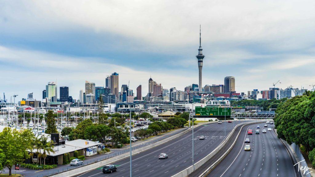 a highway with cars on it and a city skyline