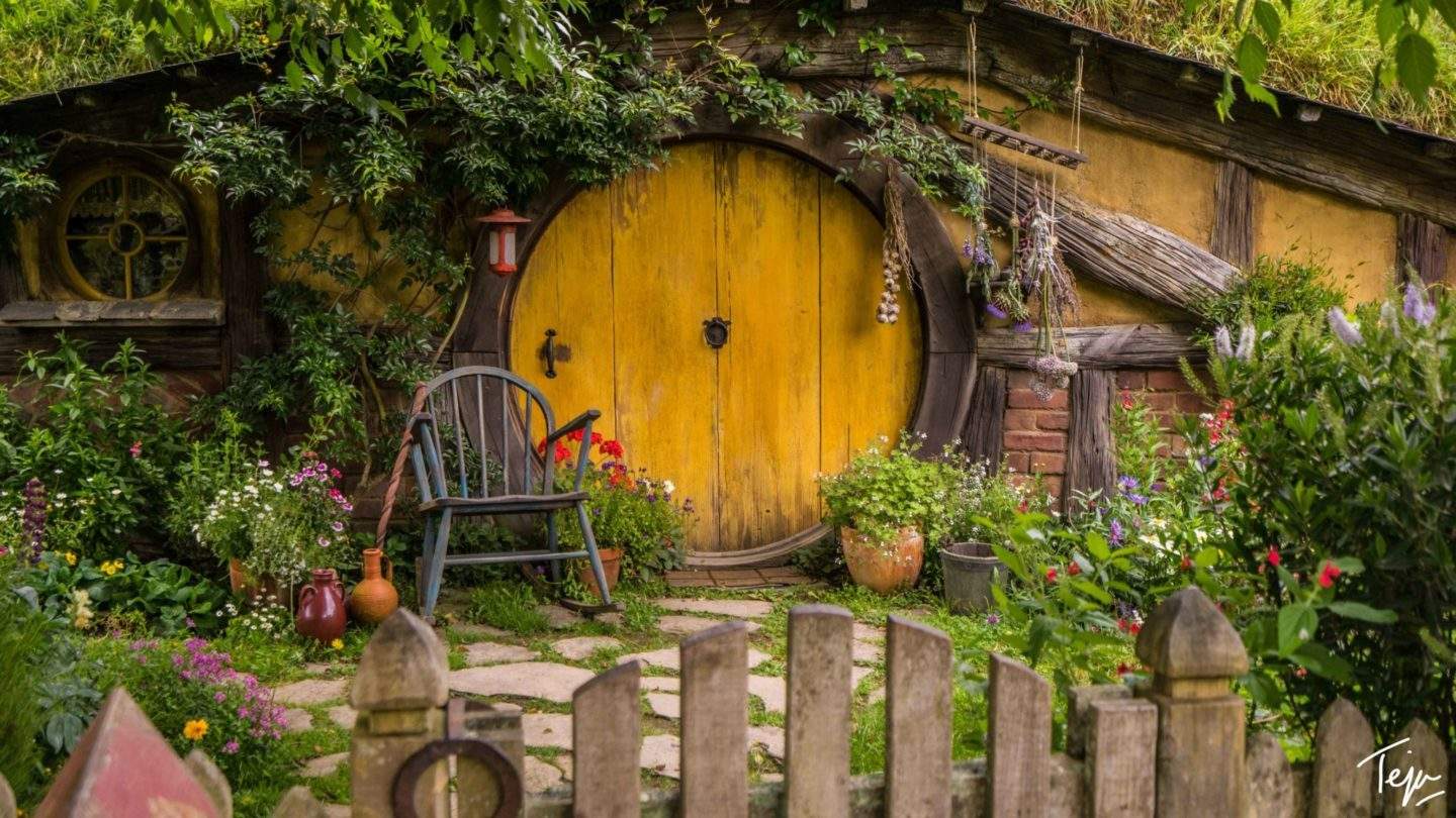 a yellow door in a garden